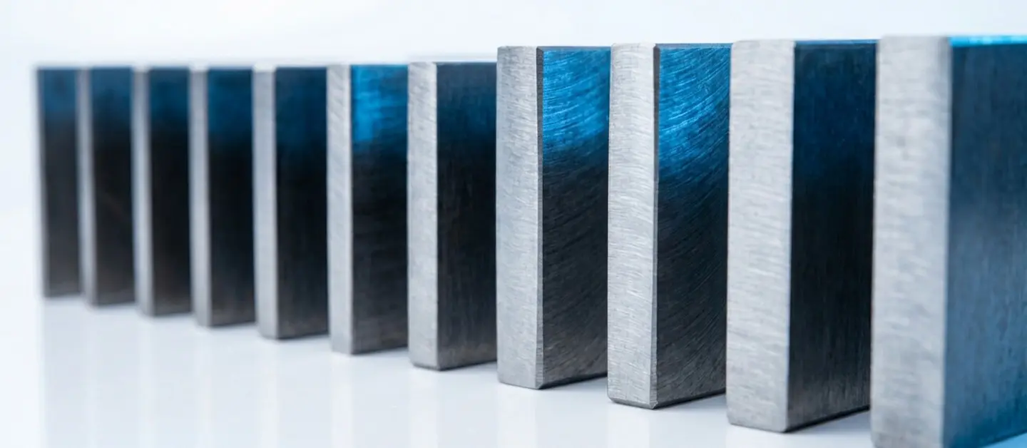 Close-up of smooth and vertical cut edges on various thicknesses of carbon steel laser cutting samples.