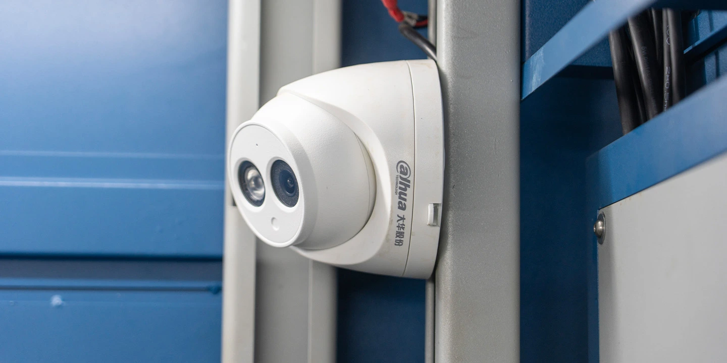AI-based obstacle detection and light curtains for pallet changer safety.
